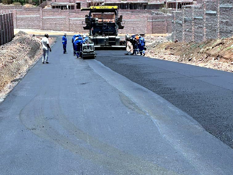 Fresh asphalt lay — main access road